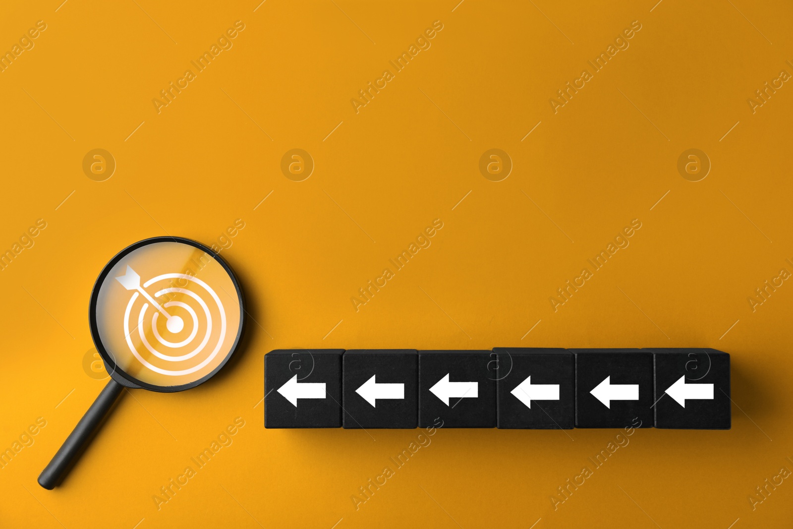 Targeting. Cubes with arrows pointing at magnifying glass with bullseye inside on orange background, top view Image of Targeting. Cubes with arrows pointing at magnifying glass with bullseye inside on orange background, top view