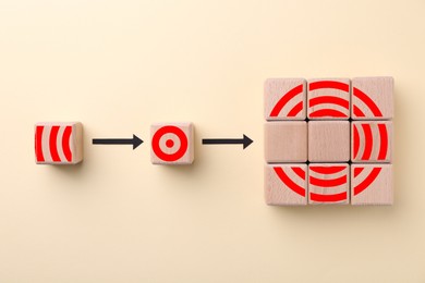 Image of Targeting. Empty wooden cubes must be replaced by others one with elements to make image of bullseye on beige background, top view