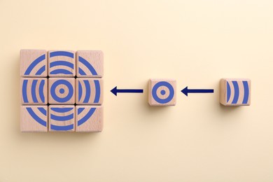 Image of Targeting. Bullseye image made of wooden cubes on beige background, top view. Cubes with elements as parts of whole