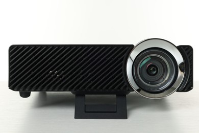 Photo of One modern video projector isolated on white