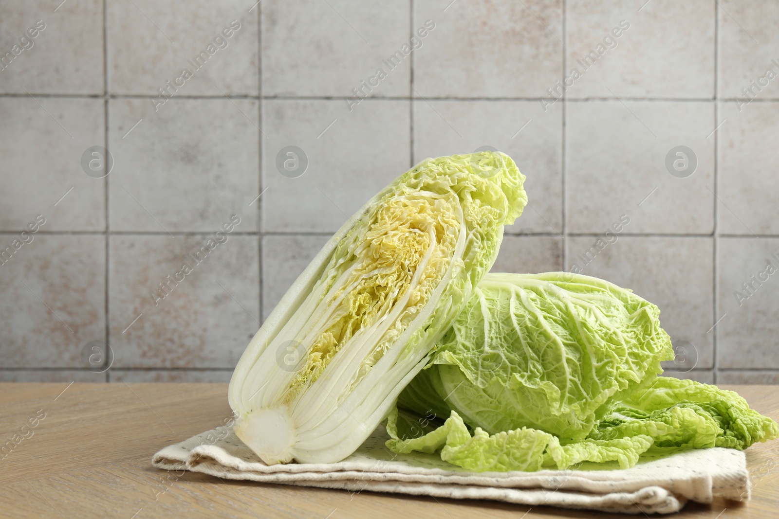 Fresh Chinese cabbages on wooden table, space for text Photo of Fresh Chinese cabbages on wooden table, space for text