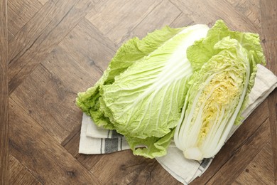 Photo of Fresh Chinese cabbages on wooden table, top view
