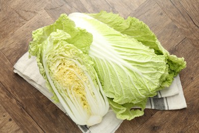 Photo of Fresh Chinese cabbages on wooden table, top view