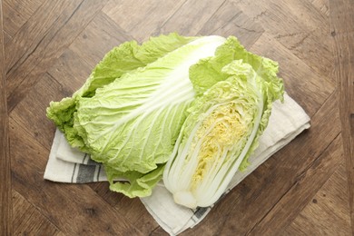 Photo of Fresh Chinese cabbages on wooden table, top view