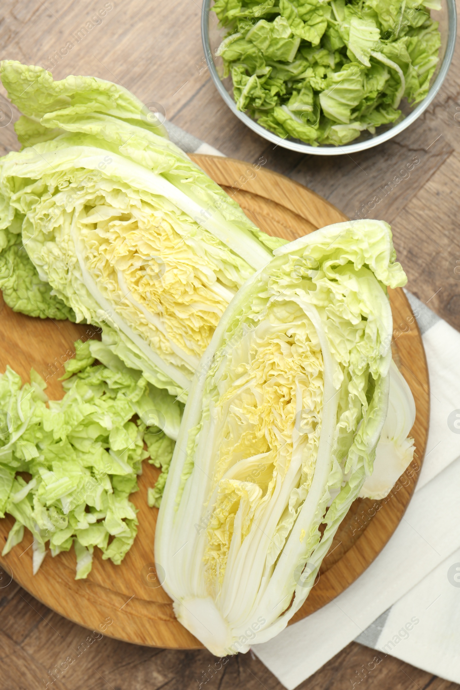 Fresh cut Chinese cabbage on wooden table, flat lay Photo of Fresh cut Chinese cabbage on wooden table, flat lay