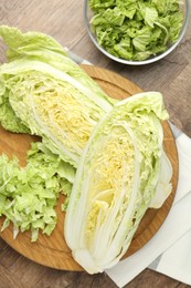 Photo of Fresh cut Chinese cabbage on wooden table, flat lay