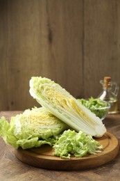 Photo of Fresh cut Chinese cabbage on wooden table, space for text