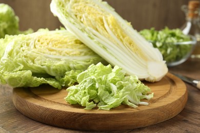Photo of Fresh cut Chinese cabbage on wooden table, closeup