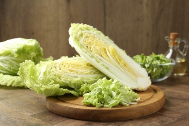 Photo of Fresh cut Chinese cabbage on wooden table