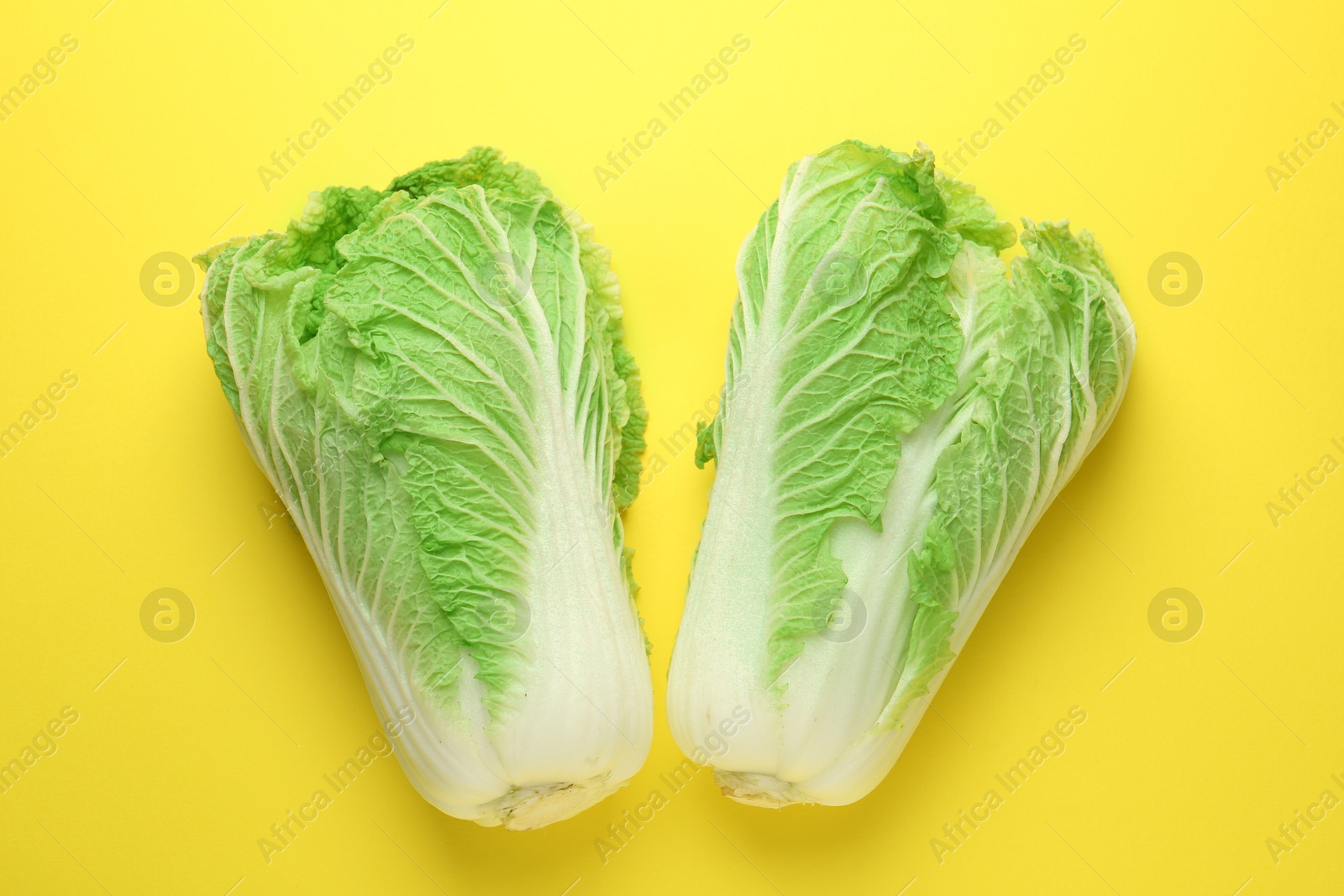 Fresh Chinese cabbages on yellow background, top view Photo of Fresh Chinese cabbages on yellow background, top view
