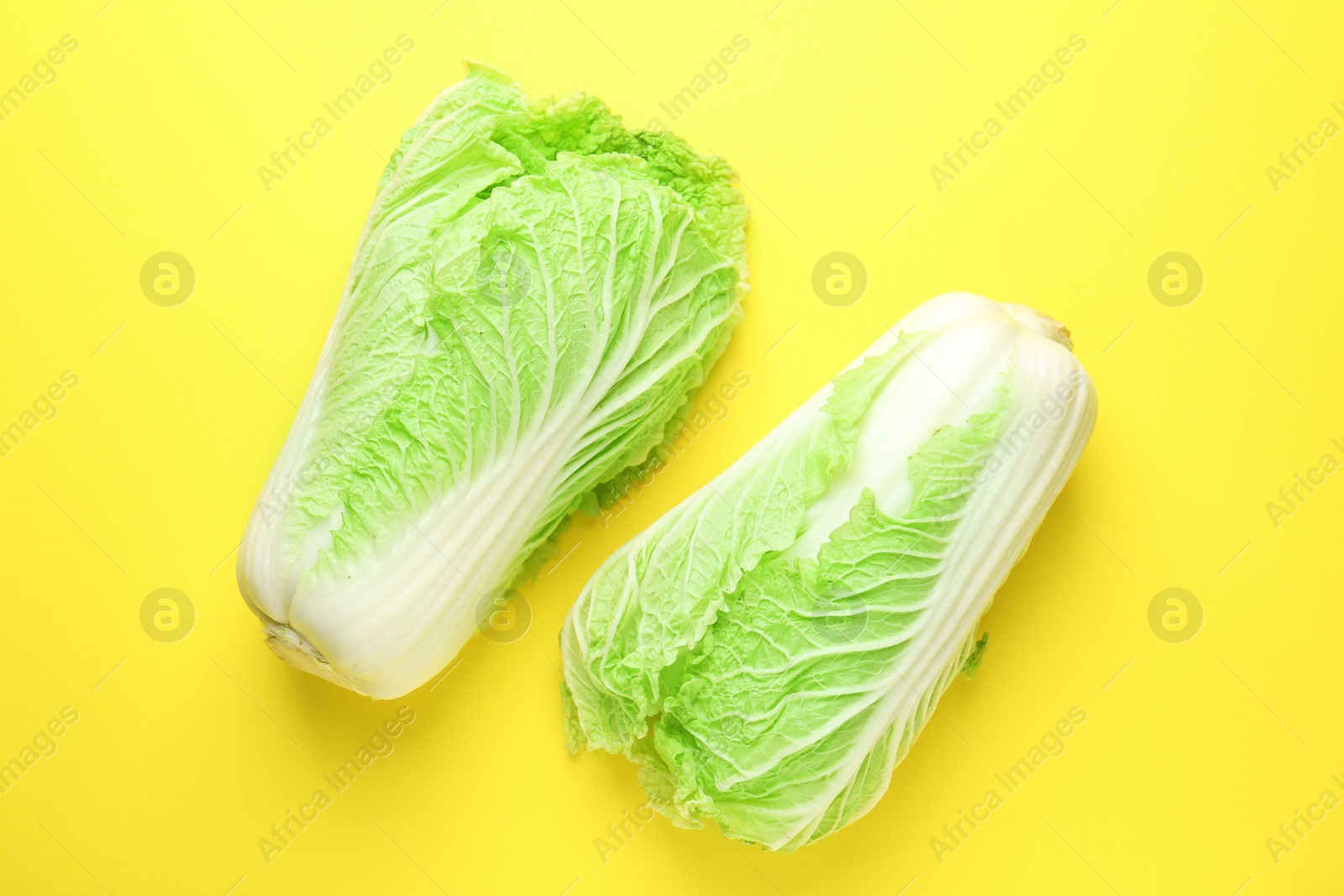 Fresh Chinese cabbages on yellow background, top view Photo of Fresh Chinese cabbages on yellow background, top view