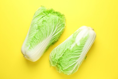 Photo of Fresh Chinese cabbages on yellow background, top view