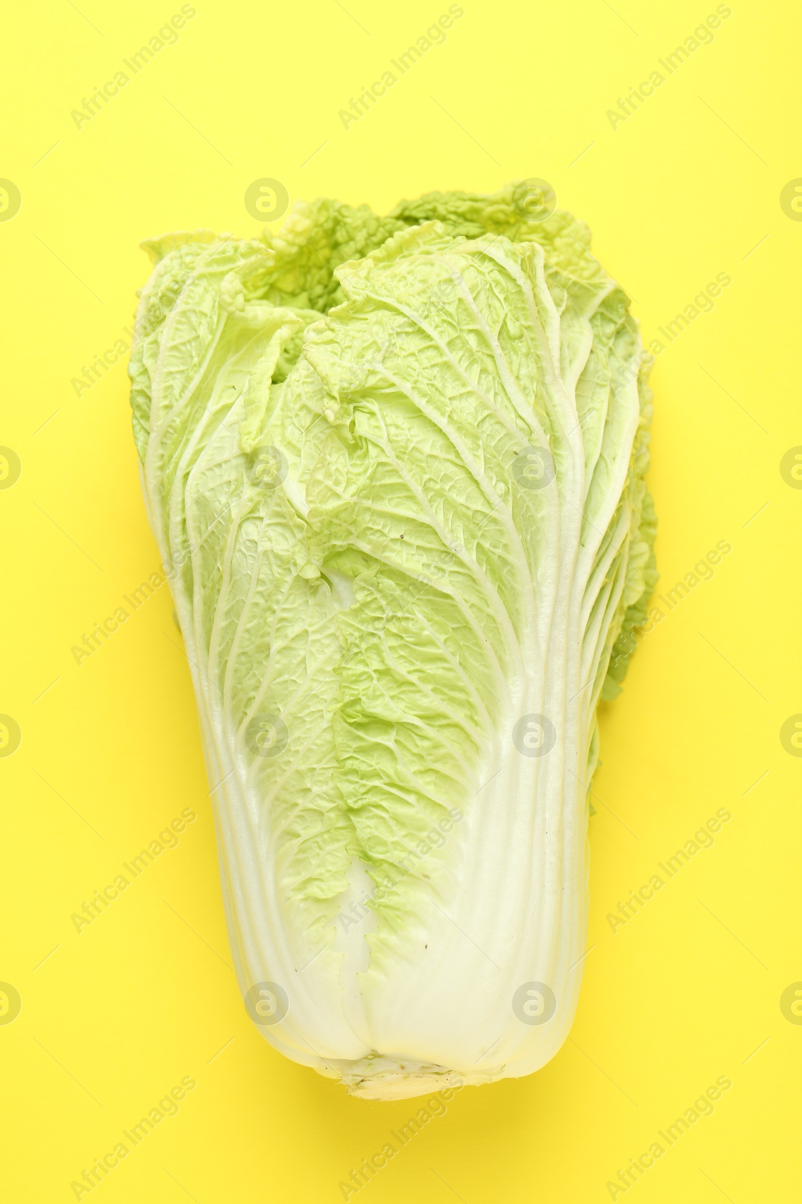 Fresh Chinese cabbage on yellow background, top view Photo of Fresh Chinese cabbage on yellow background, top view