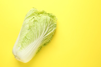 Photo of Fresh Chinese cabbage on yellow background, top view. Space for text