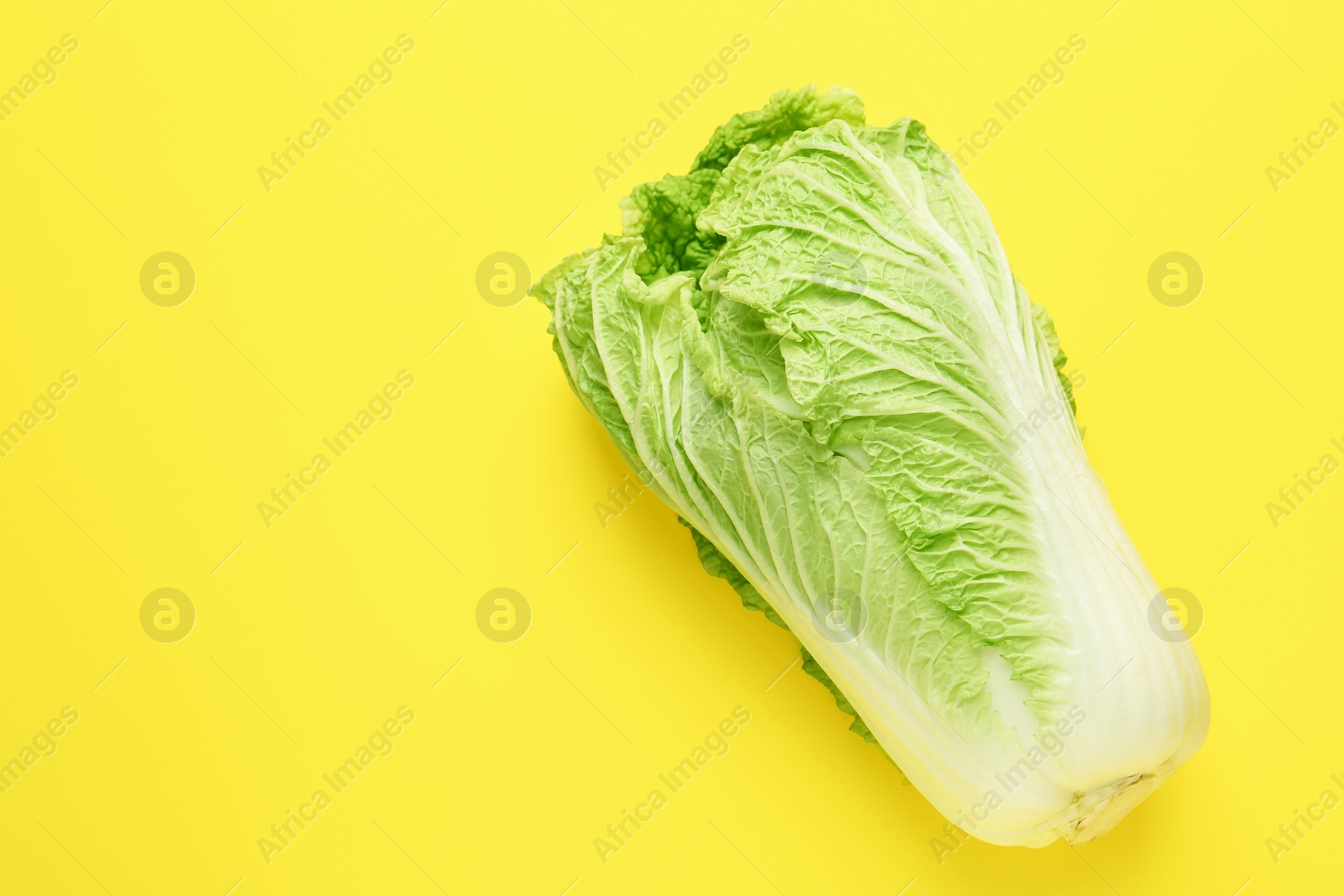 Fresh Chinese cabbage on yellow background, top view. Space for text Photo of Fresh Chinese cabbage on yellow background, top view. Space for text