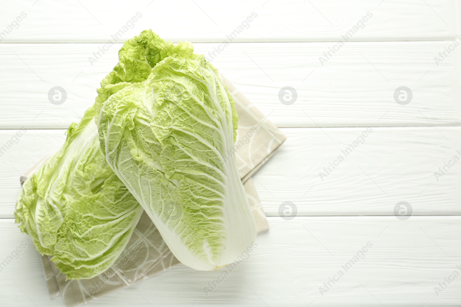 Fresh Chinese cabbages on white wooden table, top view. Space for text Photo of Fresh Chinese cabbages on white wooden table, top view. Space for text