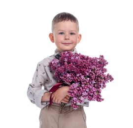 Photo of Little boy with bouquet of lilac flowers on white background