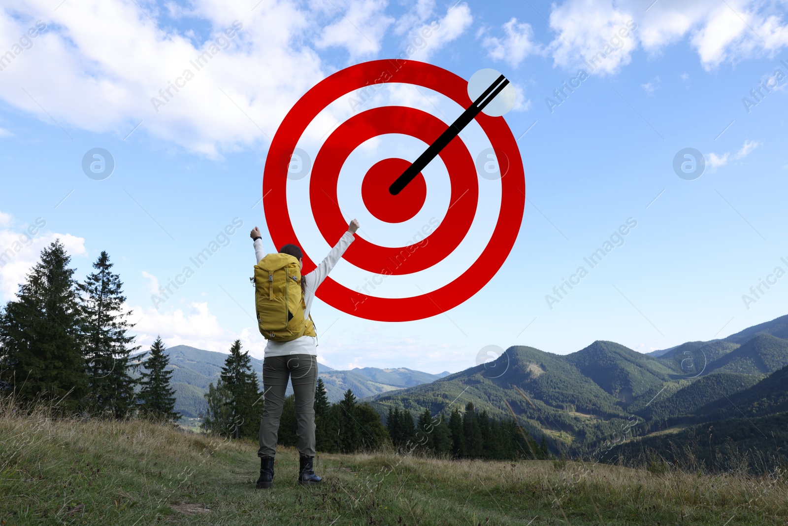 Targeting, goal achievement. Happy tourist on top of mountain in front of bullseye with arrow in sky Image of Targeting, goal achievement. Happy tourist on top of mountain in front of bullseye with arrow in sky