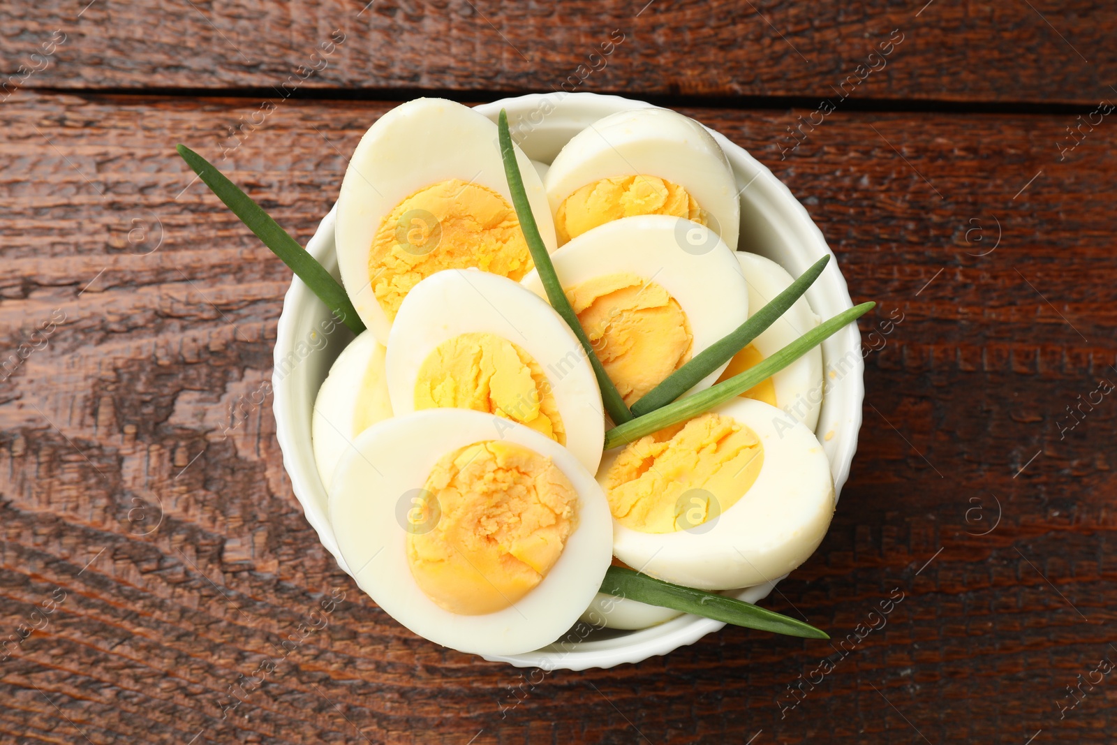 Boiled eggs and green onions on wooden table, top view Photo of Boiled eggs and green onions on wooden table, top view