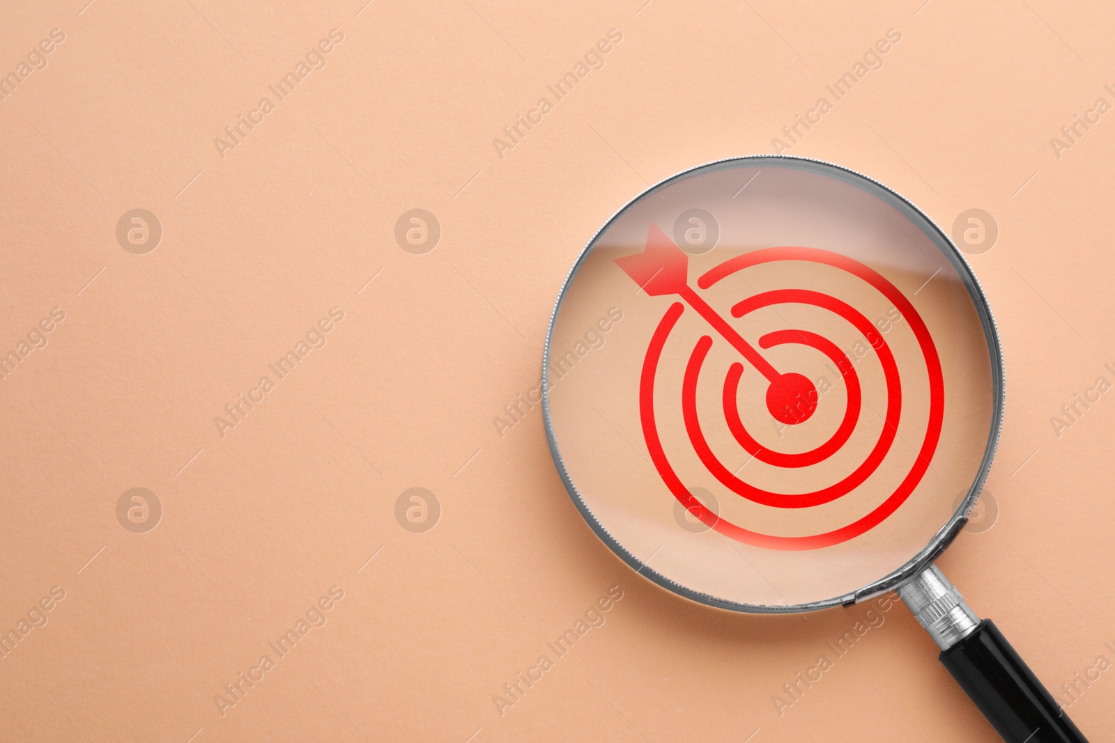Targeting. Magnifying glass with bullseye inside on dark beige background, top view. Space for text Image of Targeting. Magnifying glass with bullseye inside on dark beige background, top view. Space for text