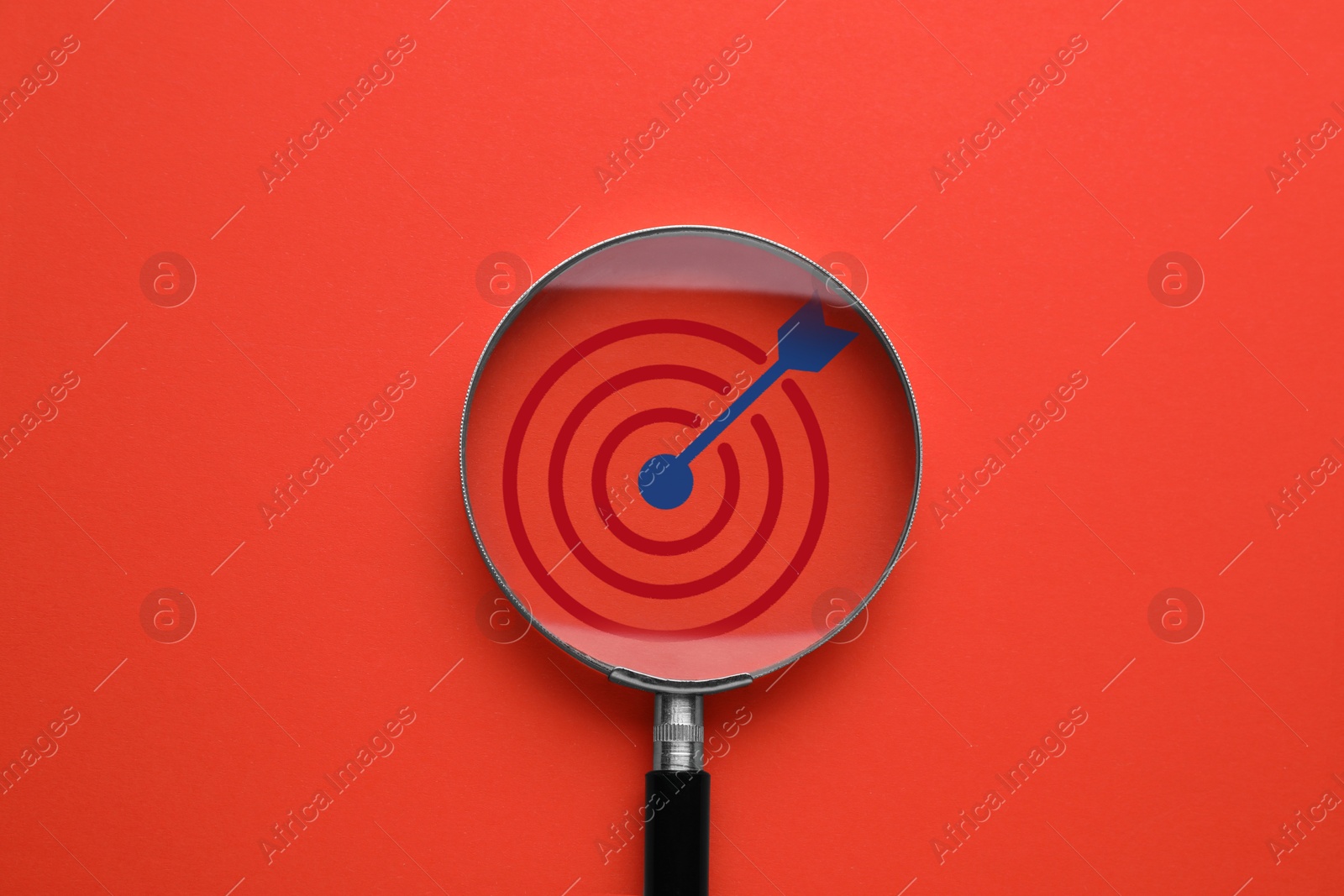 Targeting. Magnifying glass with bullseye inside on red background, top view Image of Targeting. Magnifying glass with bullseye inside on red background, top view