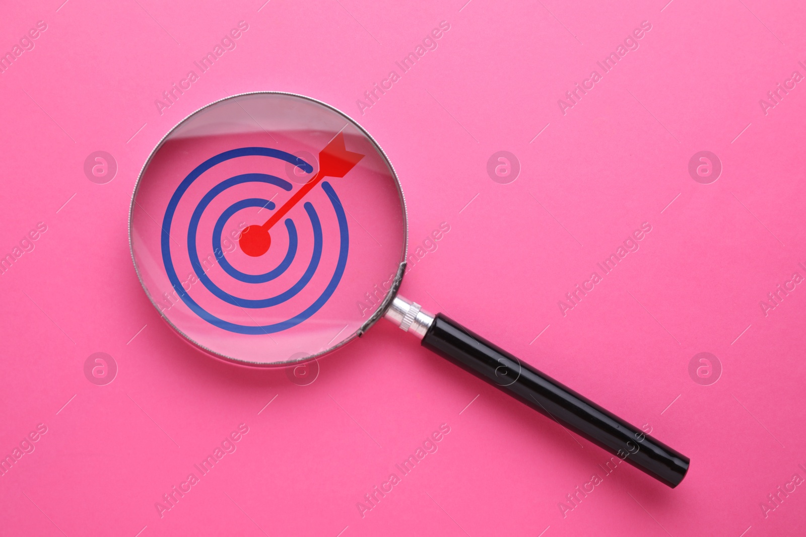 Targeting. Magnifying glass with bullseye inside on pink background, top view. Space for text Image of Targeting. Magnifying glass with bullseye inside on pink background, top view. Space for text