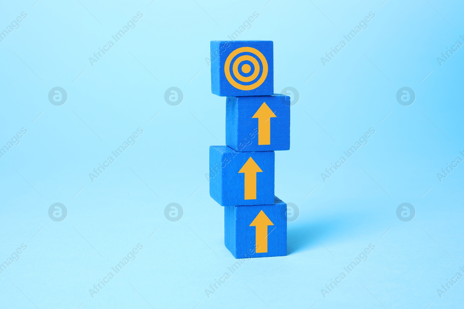 Targeting. Stacked cubes with arrows pointing at bullseye on top cube against light blue background Image of Targeting. Stacked cubes with arrows pointing at bullseye on top cube against light blue background