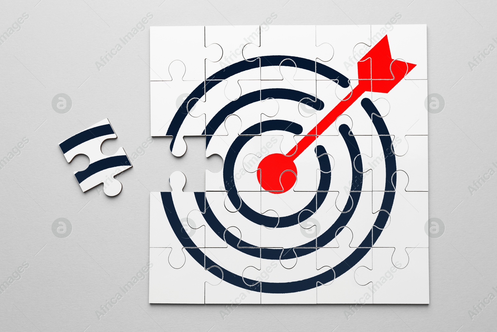 Targeting. One puzzle piece missing to make image of bullseye on light background, top view Image of Targeting. One puzzle piece missing to make image of bullseye on light background, top view