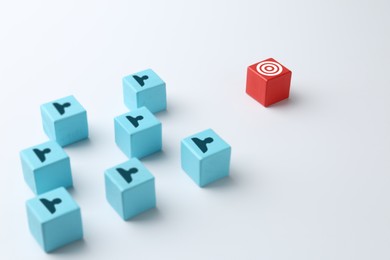 Image of Targeting. Light blue cubes with human icons and red one with bullseye on white background