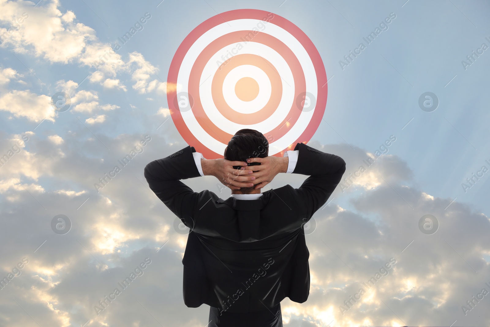 Targeting, goal achievement. Businessman looking at bullseye in sky Image of Targeting, goal achievement. Businessman looking at bullseye in sky