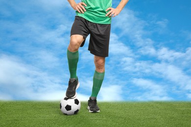 Image of Football player with soccer ball under blue sky, closeup