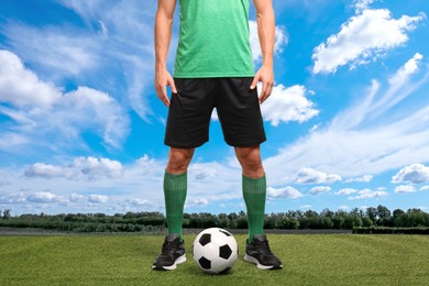Image of Football player with soccer ball under blue sky, closeup