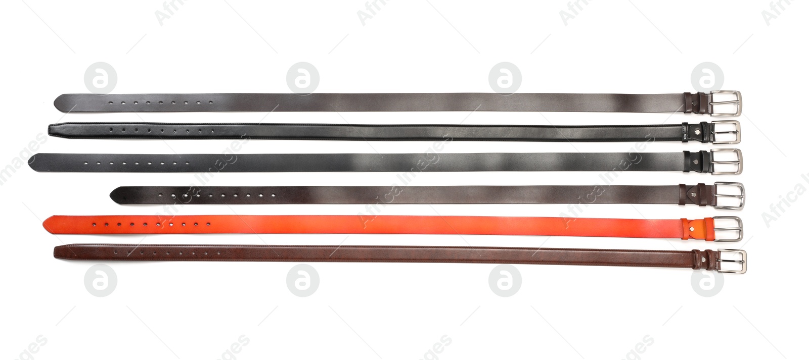 Different leather belts isolated on white, top view Photo of Different leather belts isolated on white, top view