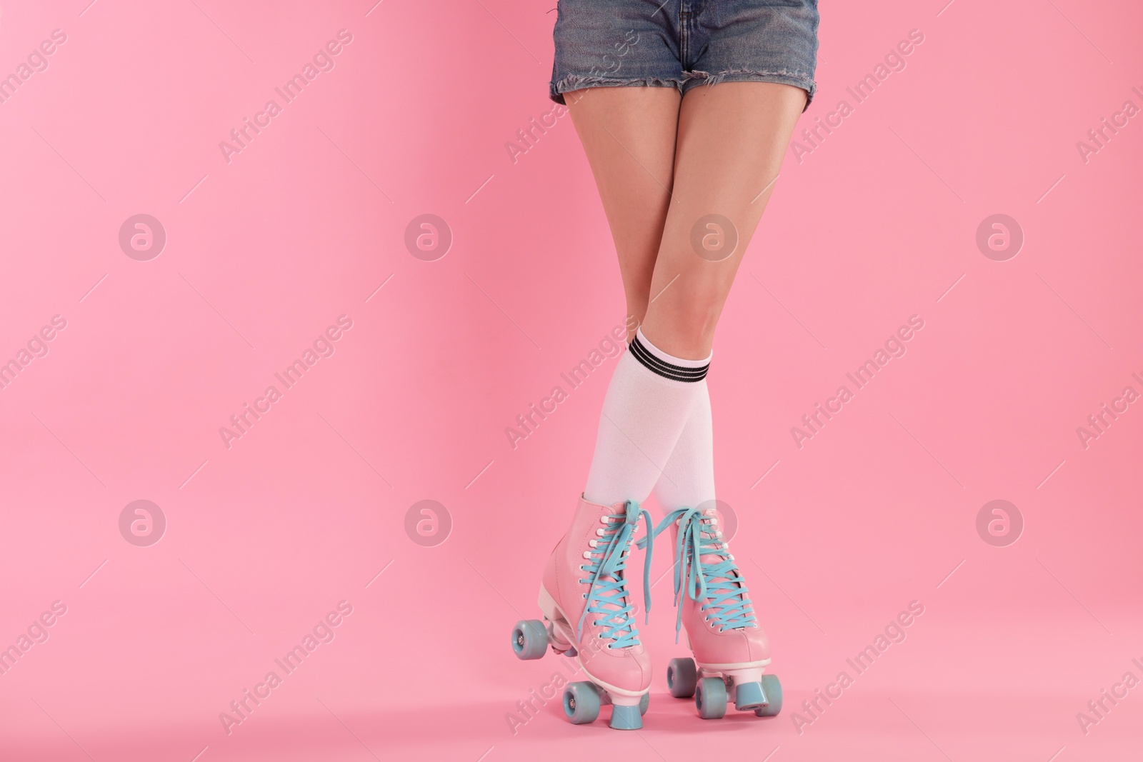 Woman in roller skates on pink background, closeup. Space for text Photo of Woman in roller skates on pink background, closeup. Space for text