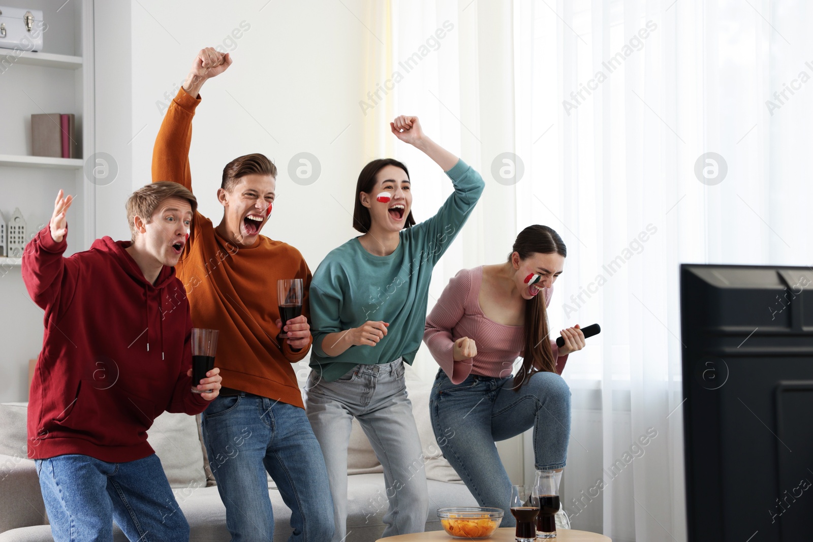 Emotional sports fans watching game together indoors Photo of Emotional sports fans watching game together indoors
