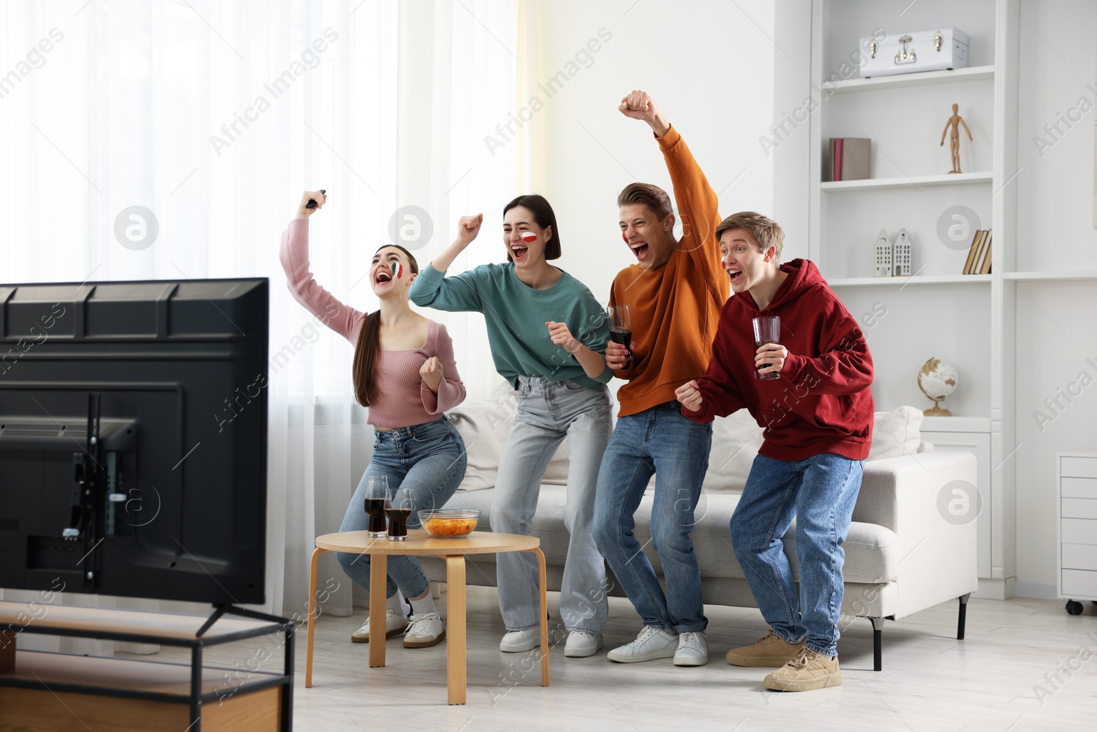 Emotional sports fans watching game together indoors Photo of Emotional sports fans watching game together indoors