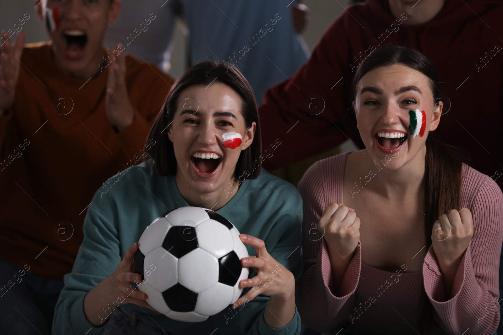 Emotional sports fans watching game together indoors, selective focus Photo of Emotional sports fans watching game together indoors, selective focus