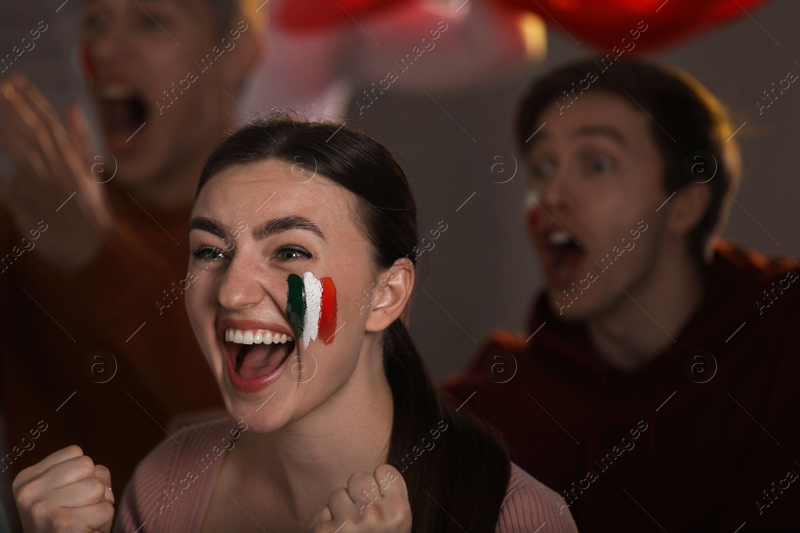 Emotional sports fans watching game together indoors, selective focus Photo of Emotional sports fans watching game together indoors, selective focus