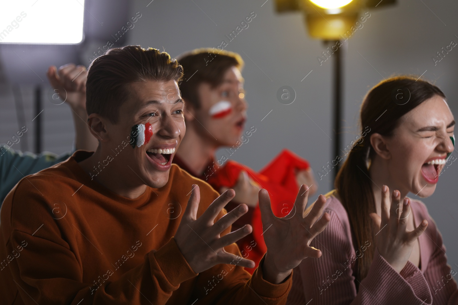 Emotional sports fans watching game together indoors Photo of Emotional sports fans watching game together indoors