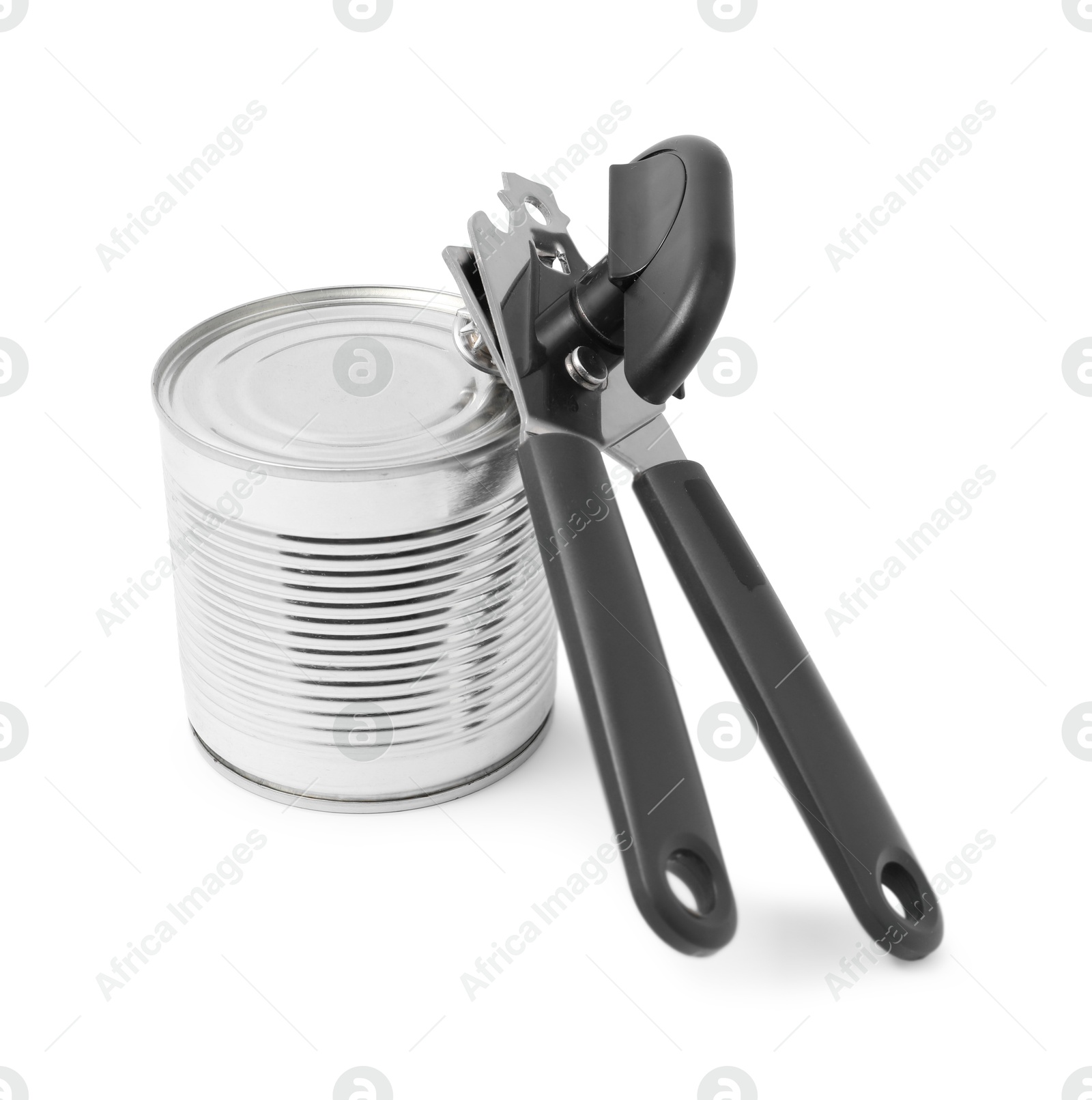 Photo of Can opener and tin isolated on white
