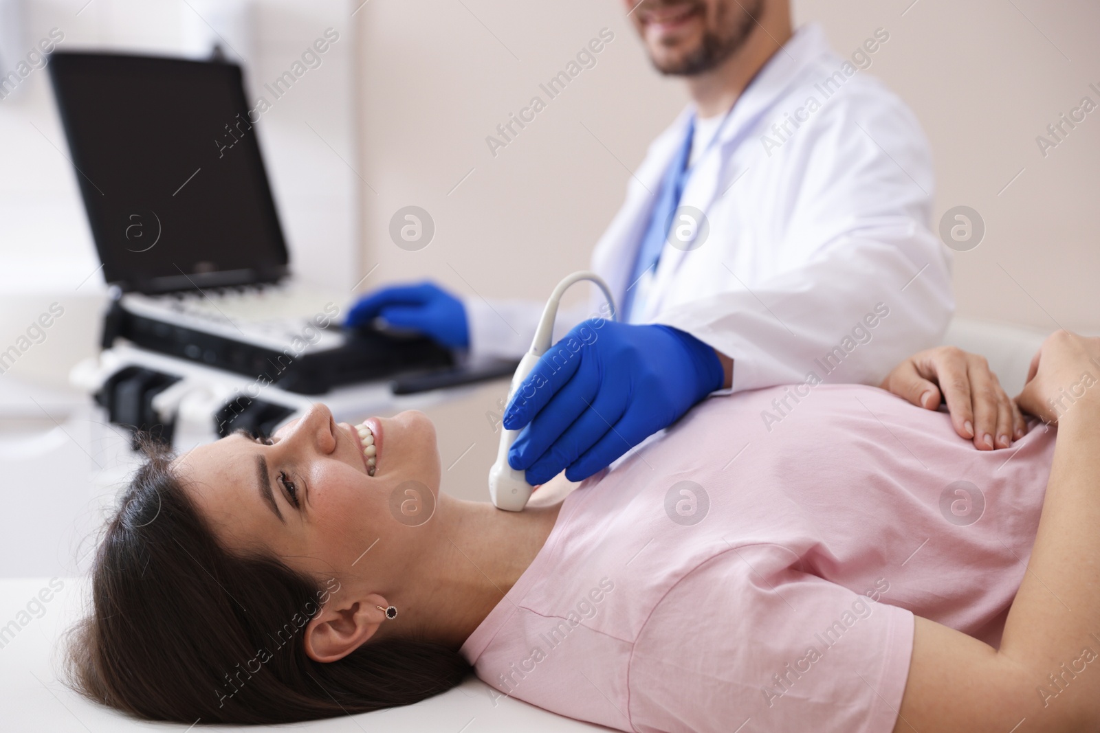 Sonographer conducting ultrasound examination of woman's thyroid gland in clinic, closeup Photo of Sonographer conducting ultrasound examination of woman's thyroid gland in clinic, closeup