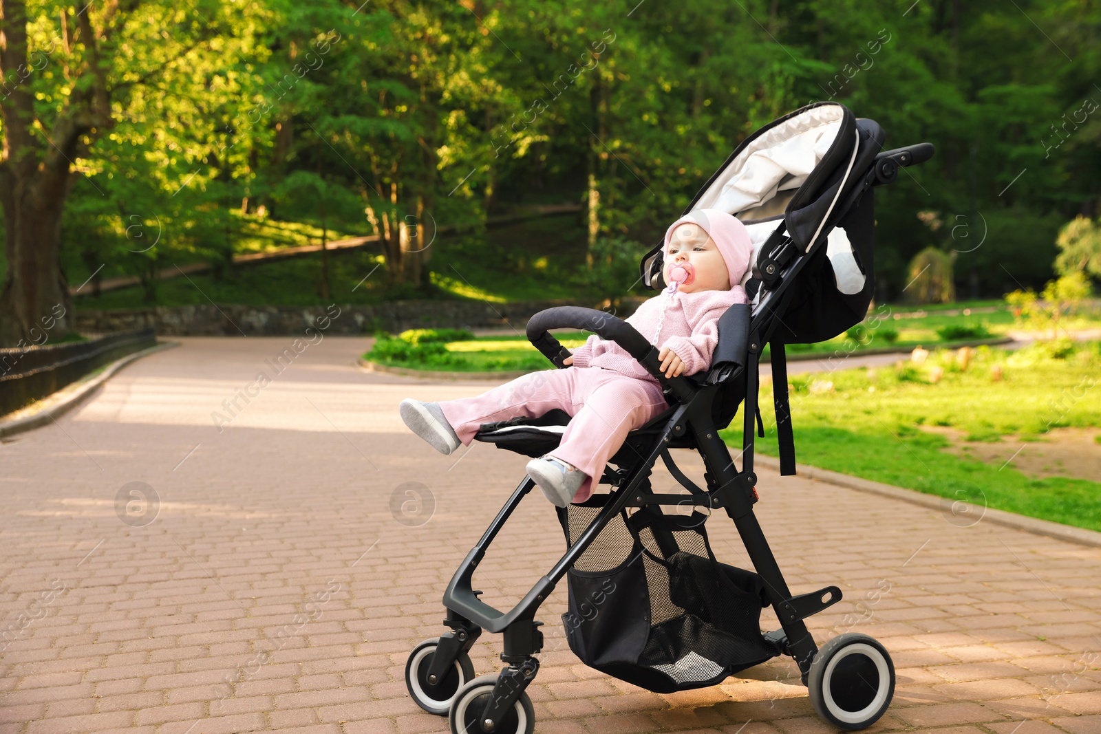Cute little baby in stroller at park. Space for text Photo of Cute little baby in stroller at park. Space for text