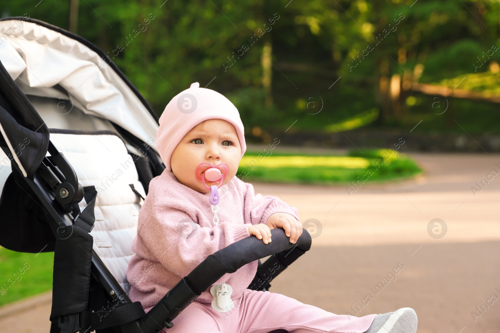 Cute little baby in stroller at park. Space for text Photo of Cute little baby in stroller at park. Space for text