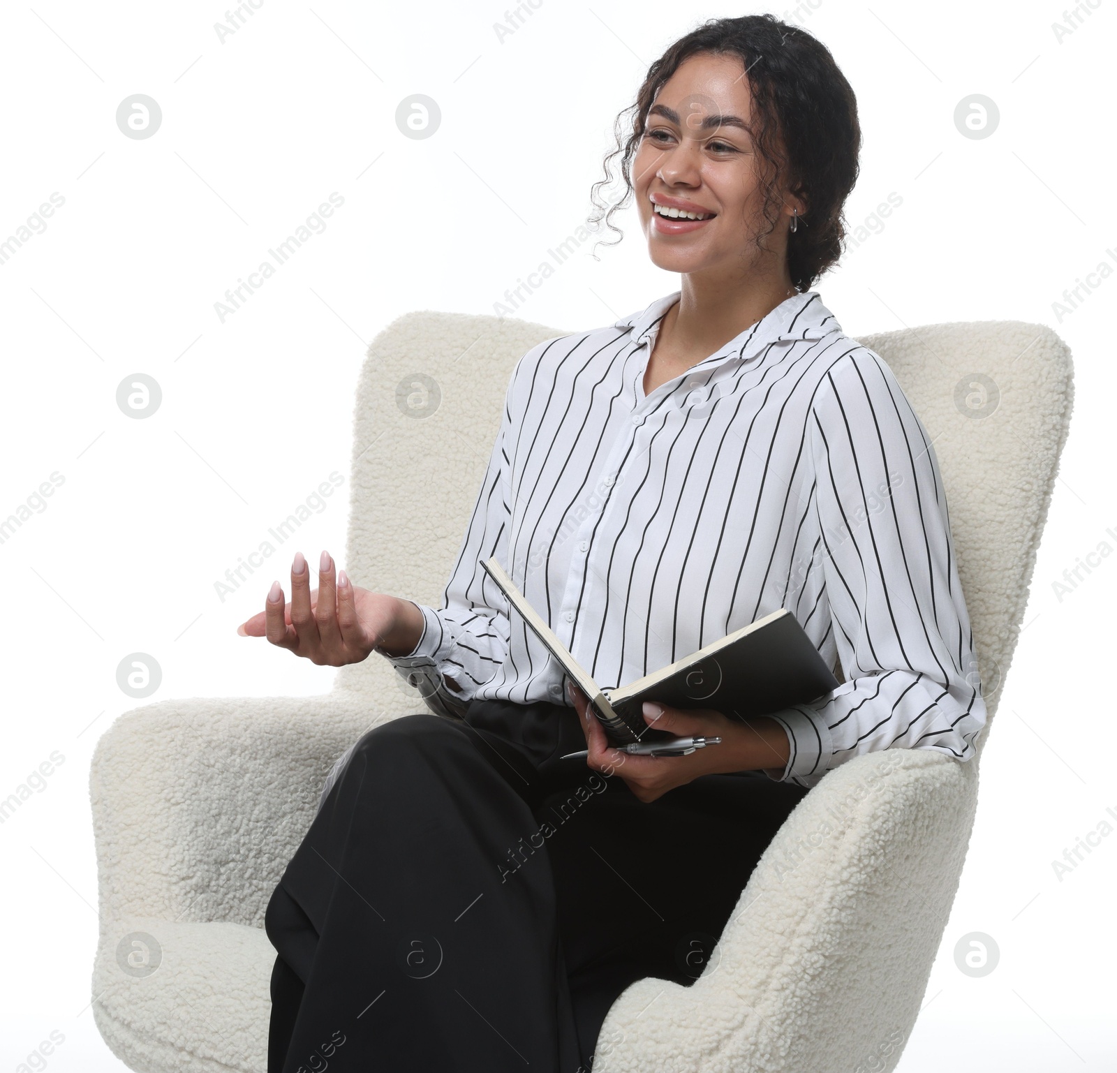 Professional psychologist with notebook and pen in armchair on white background Photo of Professional psychologist with notebook and pen in armchair on white background