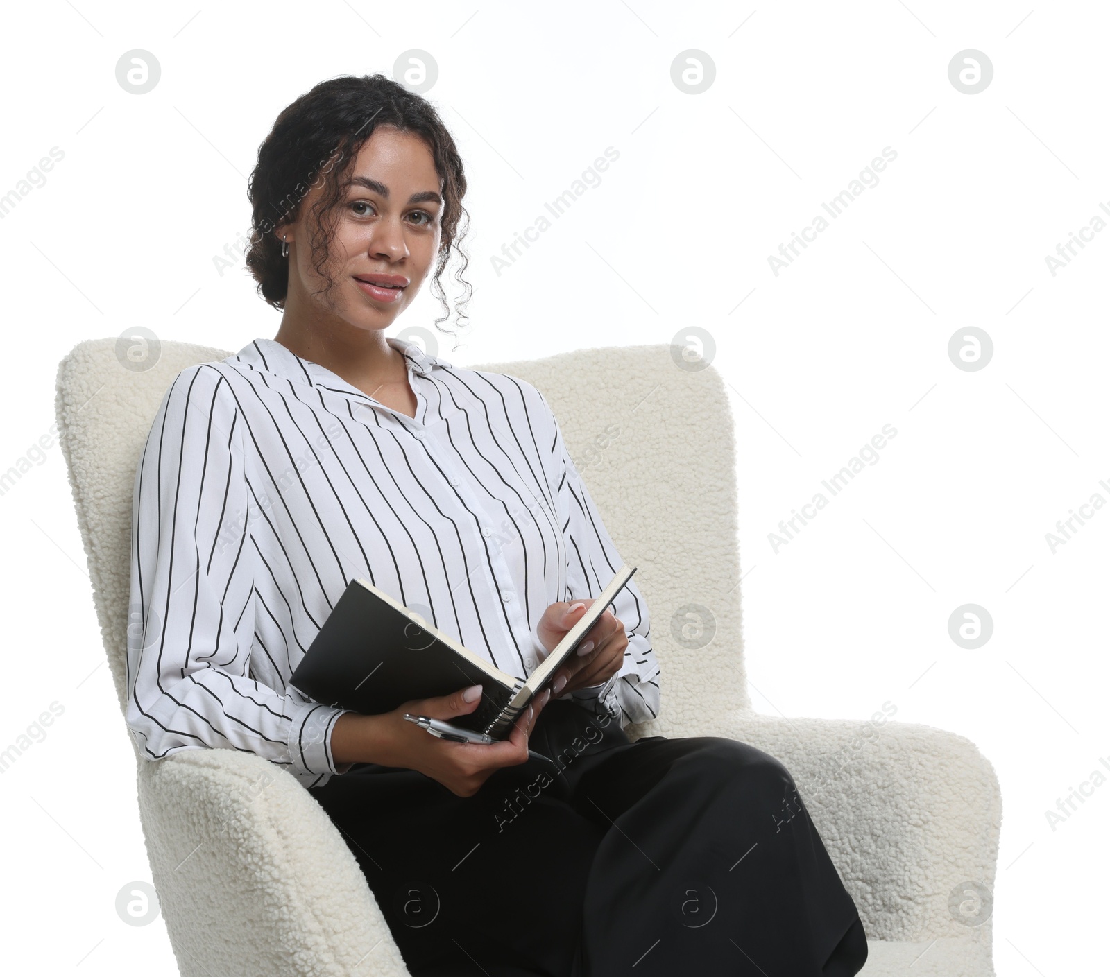 Professional psychologist with notebook and pen in armchair on white background Photo of Professional psychologist with notebook and pen in armchair on white background