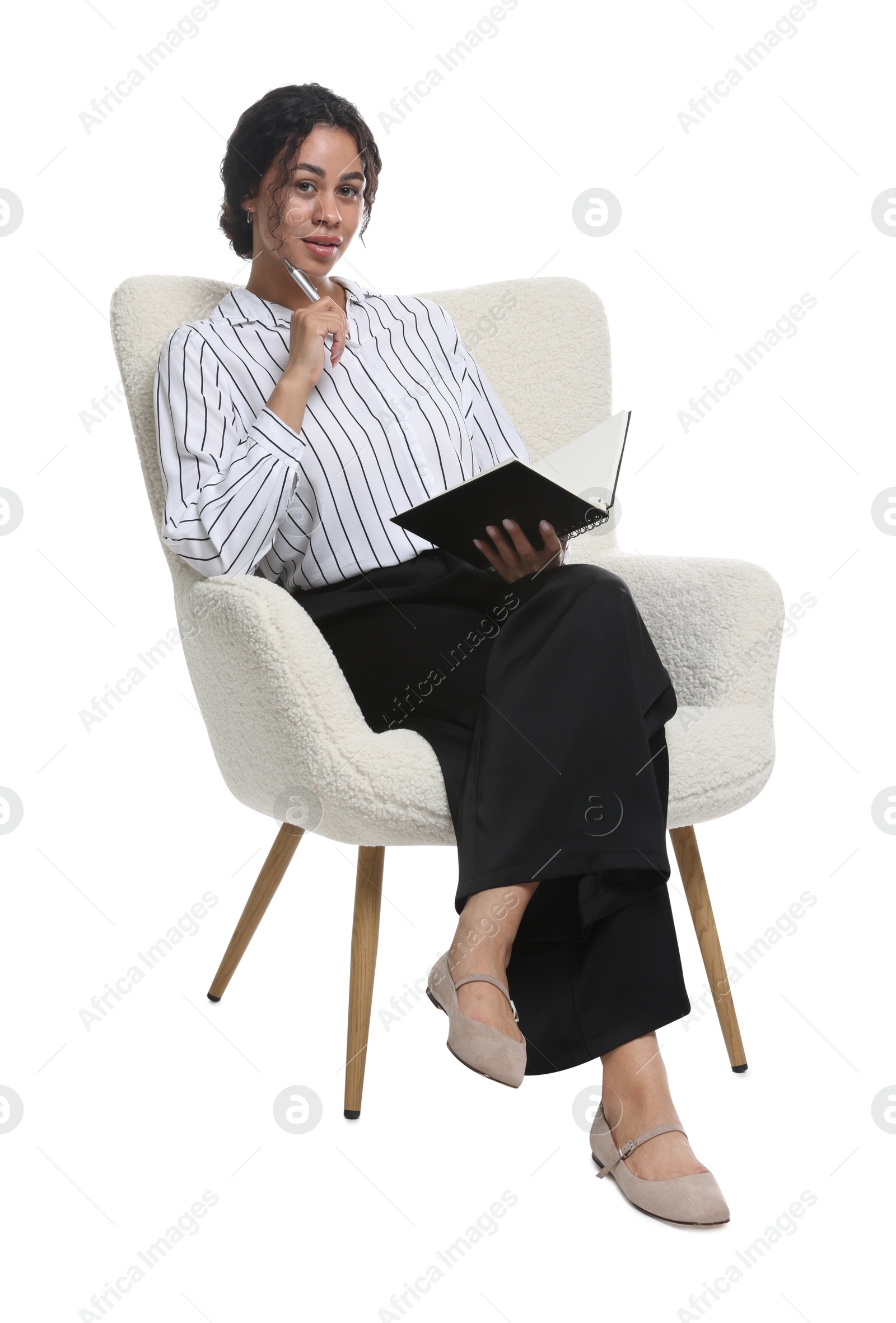 Professional psychologist with notebook and pen in armchair on white background Photo of Professional psychologist with notebook and pen in armchair on white background