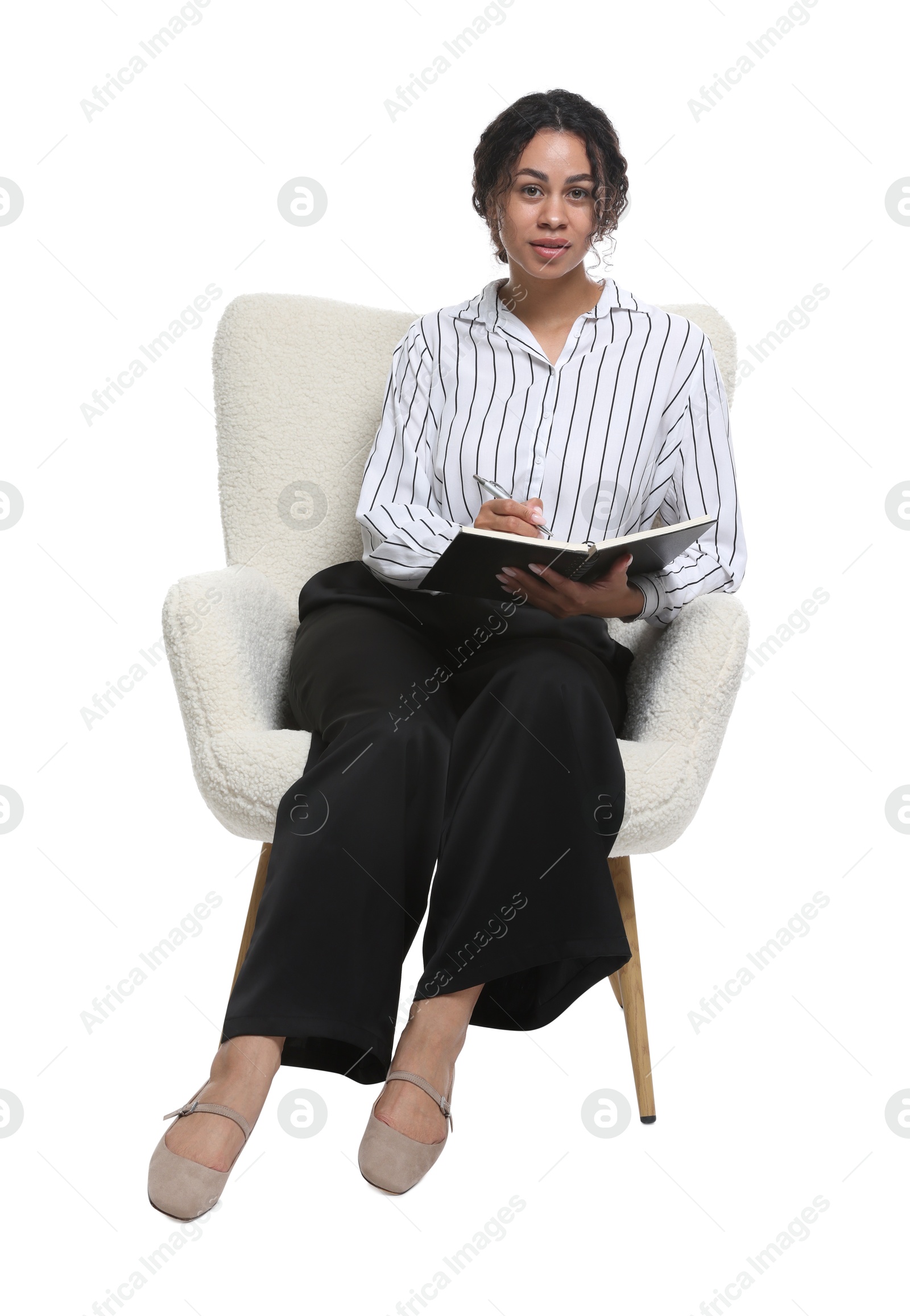 Professional psychologist with notebook and pen in armchair on white background Photo of Professional psychologist with notebook and pen in armchair on white background