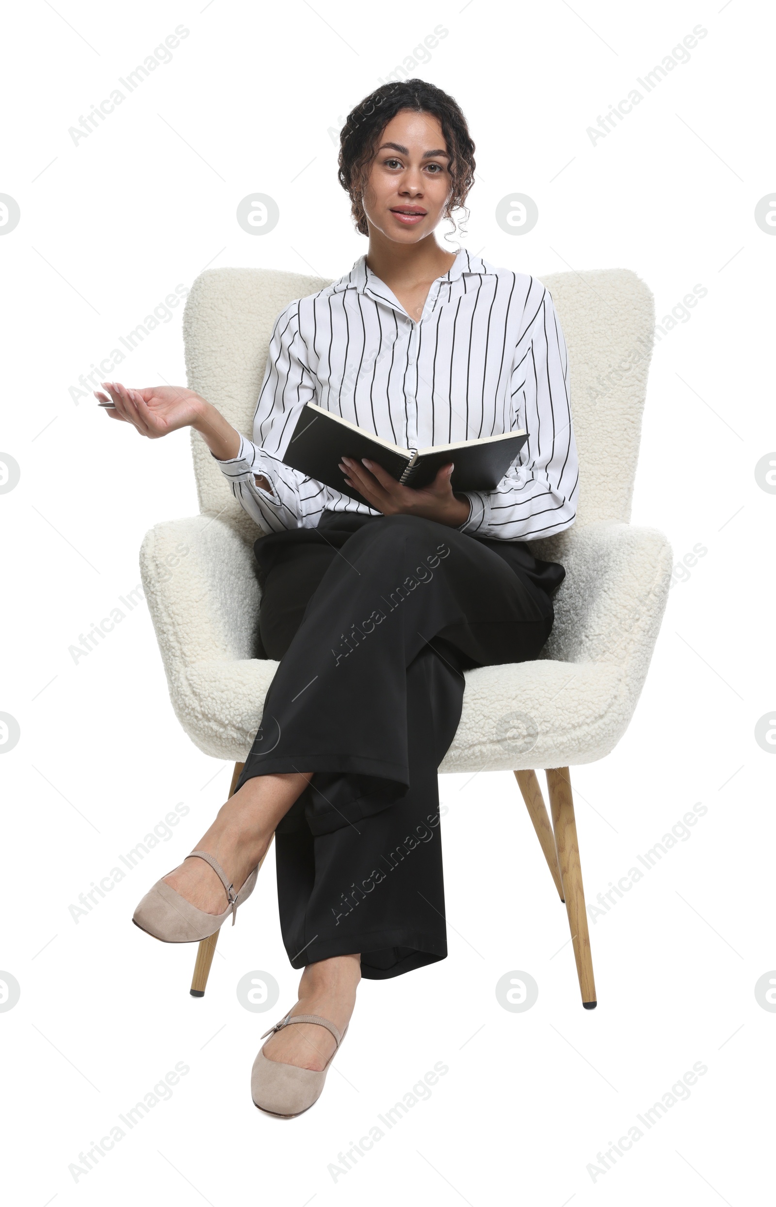 Professional psychologist with notebook and pen in armchair on white background Photo of Professional psychologist with notebook and pen in armchair on white background