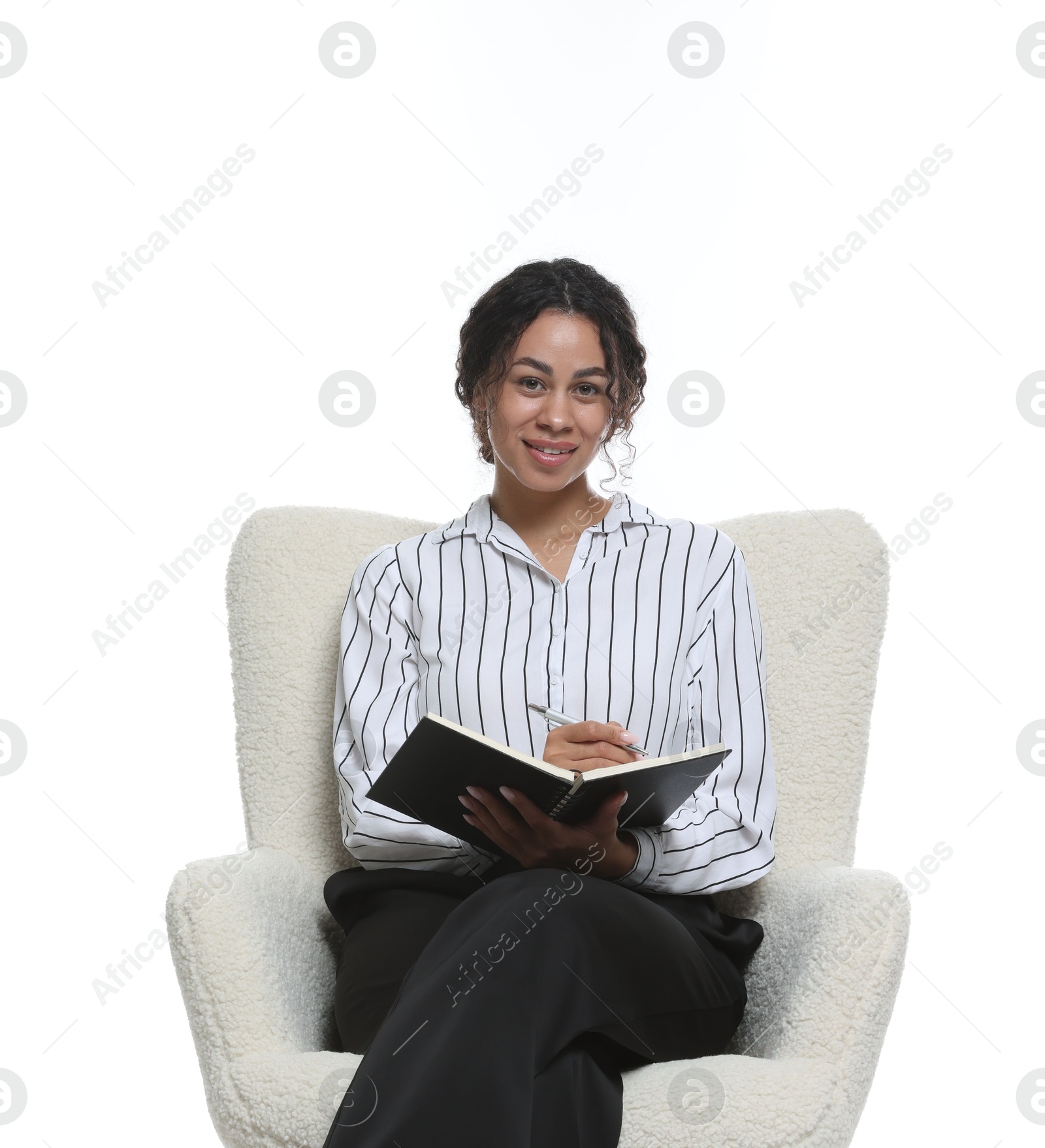 Professional psychologist with notebook and pen in armchair on white background Photo of Professional psychologist with notebook and pen in armchair on white background