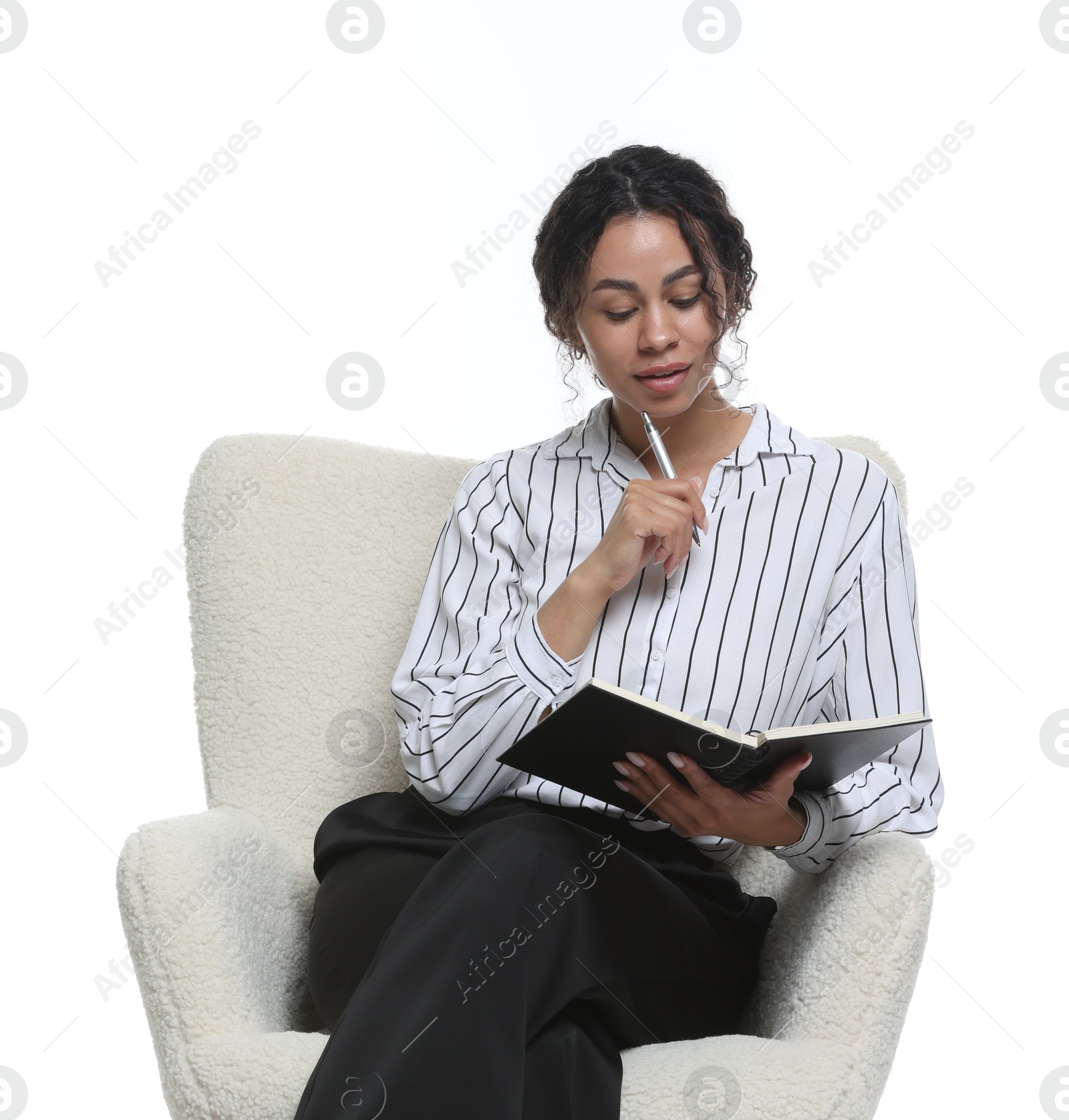 Professional psychologist with notebook and pen in armchair on white background Photo of Professional psychologist with notebook and pen in armchair on white background